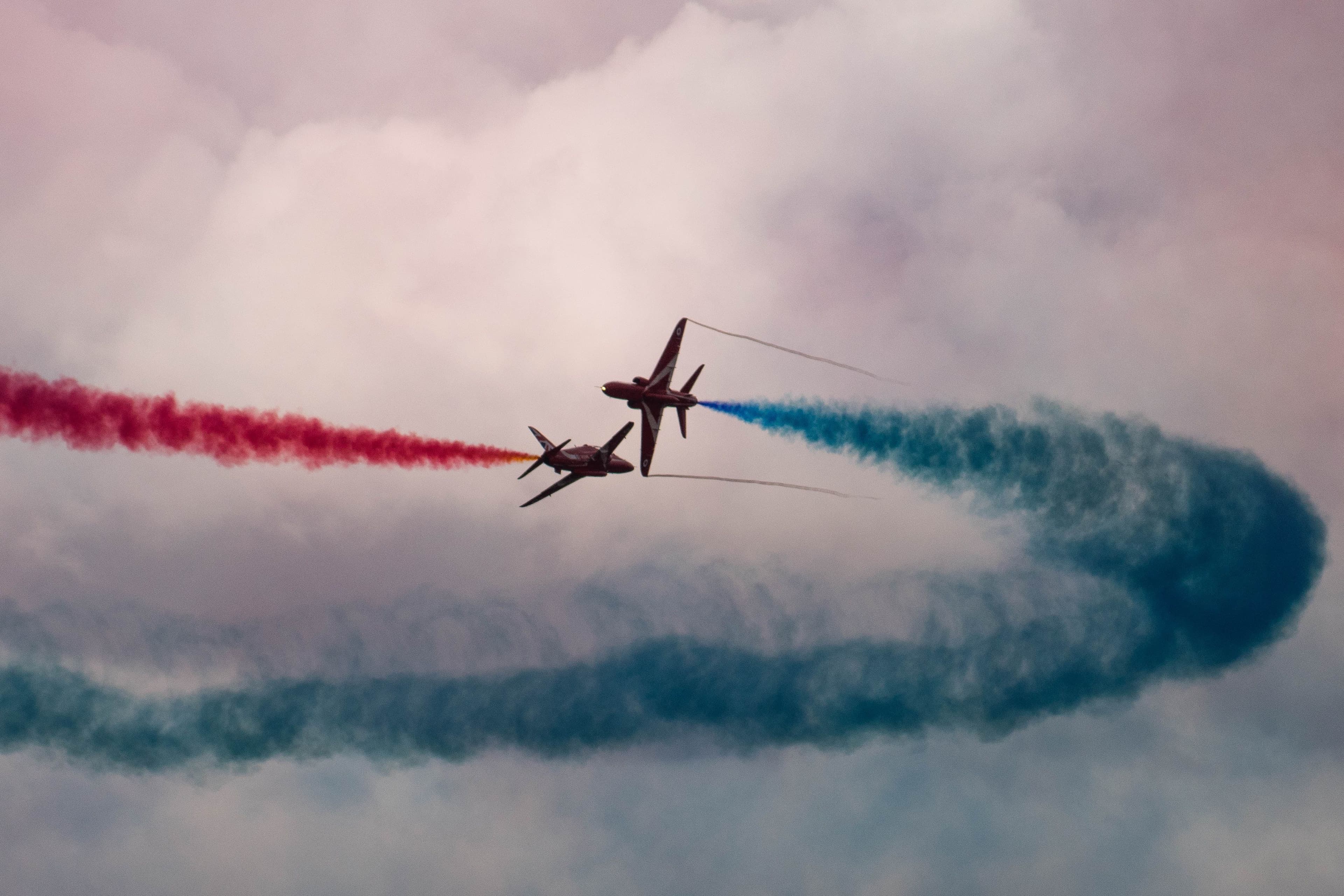 Two planes with colored exhaust trails